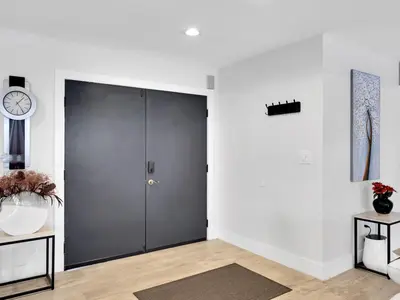 a door in a room with a clock on the wall at Tropical Dream House in Plantation 3 Bedroom Home with Pool in Plantation