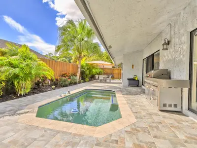 a swimming pool in the middle of a yard at Tropical Dream House in Plantation 3 Bedroom Home with Pool in Plantation