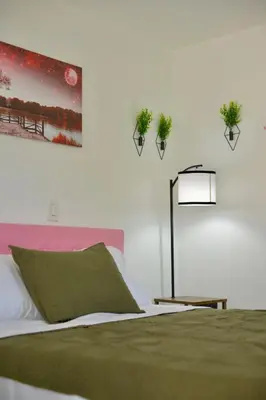 a bedroom with a bed with plants on the wall at Spacious Studio heart Of Miami in Miami