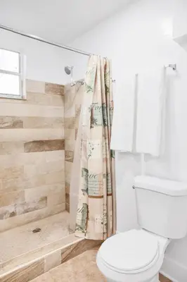 a bathroom with a toilet and a shower at Miami Designer Apartment Unit 3 in Miami