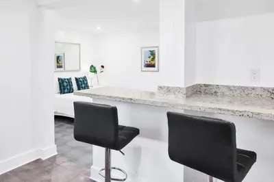 a white room with two black chairs and a counter at Miami Designer Apartment Unit 3 in Miami