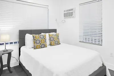 a white bedroom with a bed and a window at Miami Designer Apartment Unit 4 in Miami