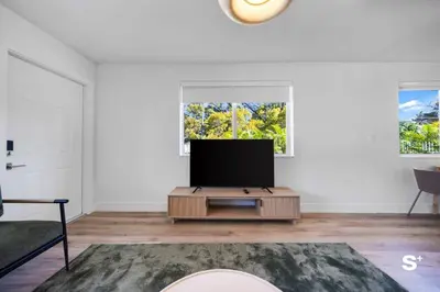 a living room with a flat screen tv on a table at Cozy 1-BD Miami Apt Gym, BBQ, Free Parking in Miami