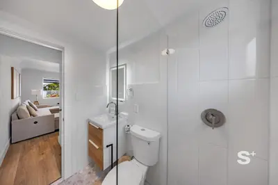 a white bathroom with a toilet and a shower at Chic 1-BD Apt in Miami Gym, BBQ, Free Parking in Miami