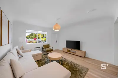 a living room with a white couch and a tv at Chic 1-BD Apt in Miami Gym, BBQ, Free Parking in Miami