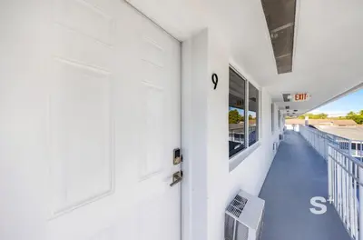 a white door on the side of a white building at Miami Retreat - 1-BR Parking, Gym & BBQ Area in Miami