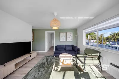 a living room with a blue couch and a tv at Miami Retreat - 1-BR Parking, Gym & BBQ Area in Miami