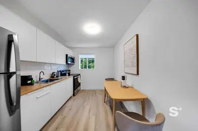 a kitchen with a wooden table and a wooden counter top at Sleek 1-BD Miami Apt Gym, BBQ, Free Parking in Miami