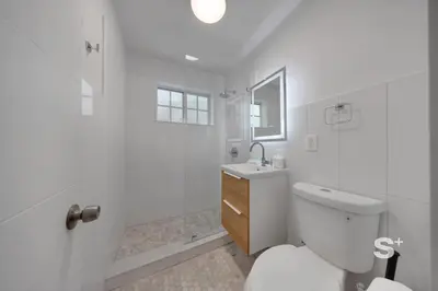 a white bathroom with a toilet and a shower at Sleek 1-BD Miami Apt Gym, BBQ, Free Parking in Miami
