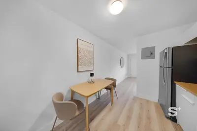 a kitchen with a table and chairs and a refrigerator at Stylish 1-BD Apt Gym, BBQ, Free Parking in Miami