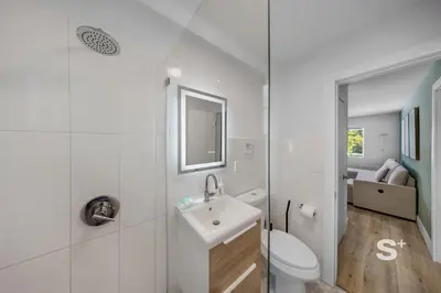 a white bathroom with a toilet and a sink at Stylish 1-BD Apt Gym, BBQ, Free Parking in Miami