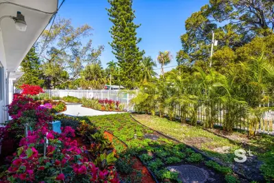 a garden with flowers and a fence at Modern 1-BD Miami Apt Gym, BBQ, Free Parking in Miami