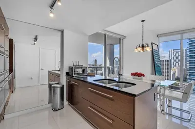 a kitchen with a sink and a large window at Moderne 2 bed 2 bath Residence in Miami