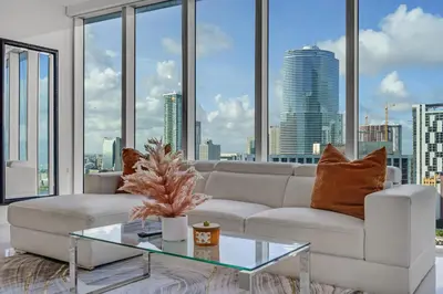 a living room with a white couch and a glass table at icon Brickell 2 bed 2bath at W residence in Miami