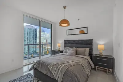 a bedroom with a bed and a large window at icon Brickell 2 bed 2bath at W residence in Miami