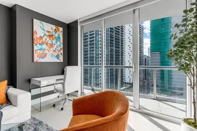 an office with a desk and a chair and windows at Icon brickell 1 bed 1 bath residence in Miami