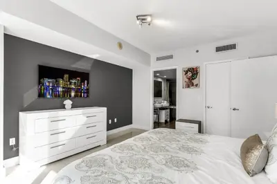 a bedroom with a white bed and a tv on the wall at Icon brickell 1 bed 1 bath residence in Miami