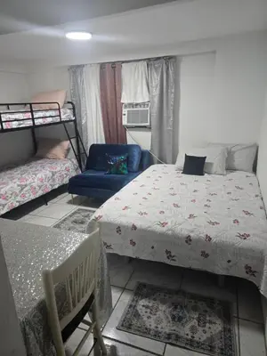 a bedroom with a bed and a chair and a couch at Land of the free in Miami