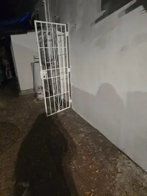 a metal gate on the side of a wall at Land of the free in Miami