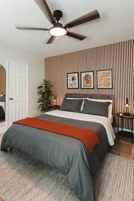 a bedroom with a large bed with a ceiling fan at Cozy Miami Suite with FREE Parking in Miami