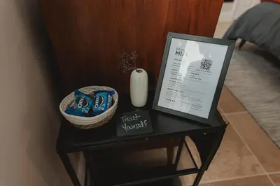 a table with a sign and a vase on it at Cozy Miami Suite with FREE Parking in Miami