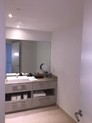 a bathroom with a sink and a large mirror at LYFE, Rent Excelent Apartment in Resort, 4Pax ,Parcial Ocean View in Hollywood