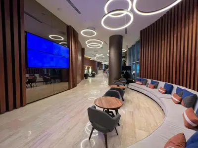 a lobby with couches and chairs and a large screen at LYFE, Rent Excelent Apartment in Resort, 4Pax ,Parcial Ocean View in Hollywood