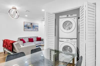 a living room with a washer and dryer at Modern Home with large private yard - Next to downtown & beach & airport - Pet friendly in Fort Lauderdale
