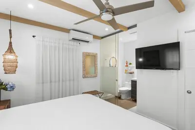a bedroom with a bed and a ceiling fan at Stunning, Modern and Quiet Beach House in Hollywood