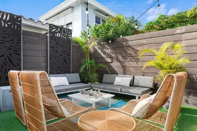 a patio with a couch and chairs and a table at Stunning, Modern and Quiet Beach House in Hollywood