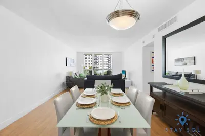 a dining room and living room with a table and chairs at Tides beautiful ocean view condo-promotions in Hollywood
