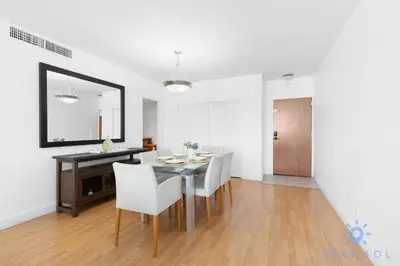 a dining room with a table and chairs and a mirror at Tides beautiful ocean view condo-promotions in Hollywood