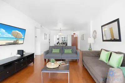 a living room with a couch and a tv at Tides Great condo on the beach Big promotions in Hollywood