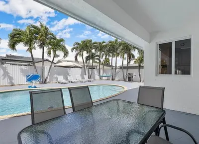 a patio with a table and chairs and a swimming pool at Miami Oasis With Private Pool in Richmond West