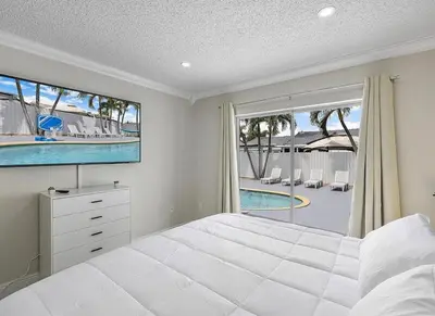 a bedroom with a large bed and a view of a pool at Miami Oasis With Private Pool in Richmond West