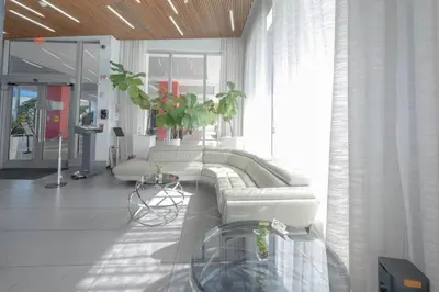 a living room with a couch and a table at Hallandale Beach Apmt 1B1B with Beach Service & Pool Service in Hallandale Beach