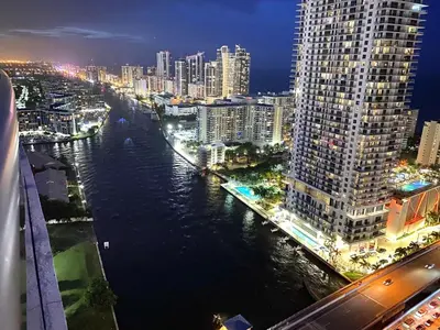 a view of a city at night with a river at Hallandale Beach Apmt 1B1B with Beach Service & Pool Service in Hallandale Beach