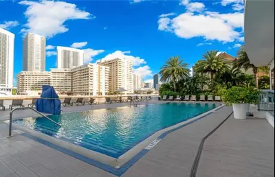 a swimming pool with a city skyline in the background at Miami Beach 1B1B Apmt Amazing Intercoastal View in Hallandale Beach