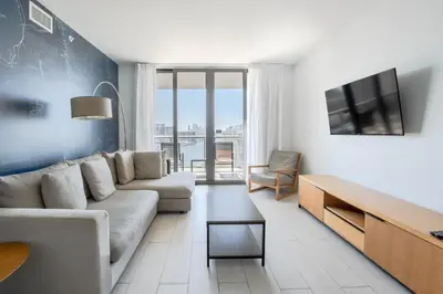 a living room with a couch and a tv at Miami Beach 1B1B Apmt Amazing Intercoastal View in Hallandale Beach