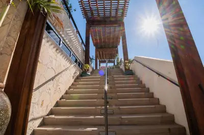 a staircase leading up to a building with the sun in the background at Miami Beach 1B1B Apmt Amazing Intercoastal View in Hallandale Beach