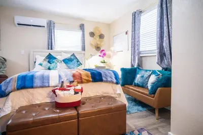 a bedroom with a bed and a couch at Hidden Gem Luxe 1 BEDROOM & Patio in Cutler Bay