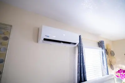 a room with a air conditioner on a wall at Hidden Gem Luxe 1 BEDROOM & Patio in Cutler Bay
