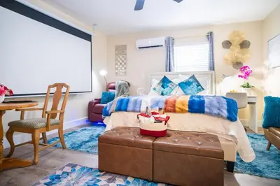 a bedroom with a bed and a table and a chair at Hidden Gem Luxe 1 BEDROOM & Patio in Cutler Bay