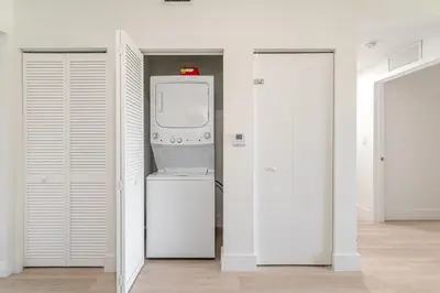 a white laundry room with a washer and dryer at New 2br 2bath 5 mins from beach 15 mins airport in Hallandale Beach