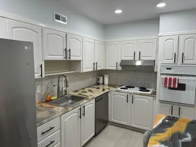 a kitchen with white cabinets and a sink at Beachfront one bedroom in the Tides in Hollywood in Hollywood