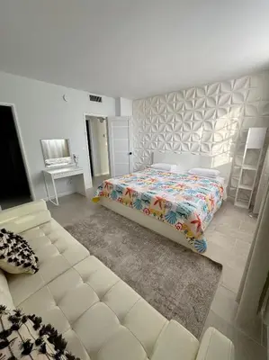 a bedroom with a bed and a couch at Beachfront one bedroom in the Tides in Hollywood in Hollywood