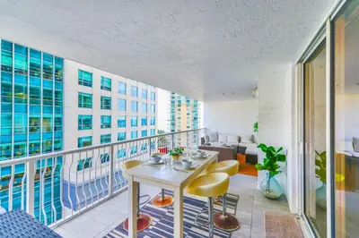 a balcony with a table and chairs on a building at Elegant Retreat Brickell in Miami