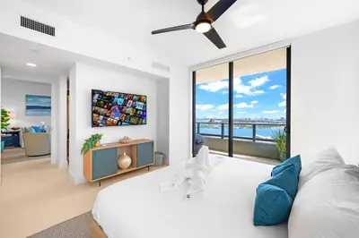 a bedroom with a white bed and a large window at Enjoy Miami From a Condo on 24th Floor in Miami