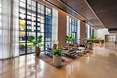 a lobby with a couch and chairs and large windows at Enjoy Miami From a Condo on 24th Floor in Miami