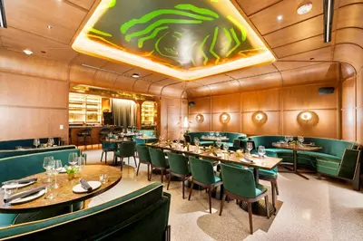 a dining room with tables and green chairs at Enjoy Miami From a Condo on 24th Floor in Miami
